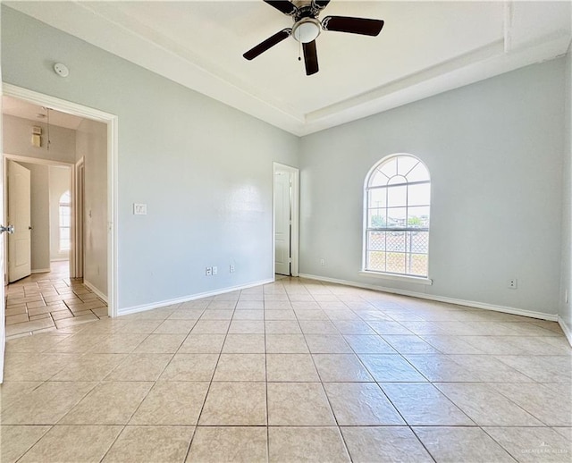 tiled empty room with ceiling fan