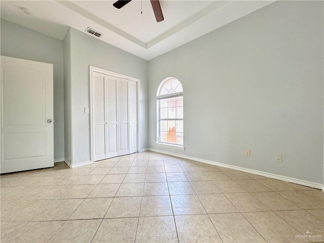 unfurnished bedroom featuring light tile patterned floors, ceiling fan, and a closet