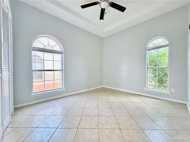 empty room featuring light tile patterned floors and ceiling fan