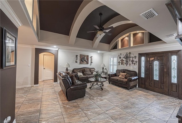 living room featuring ceiling fan, ornamental molding, and vaulted ceiling