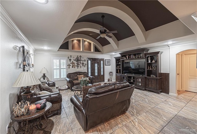 living room featuring lofted ceiling, ceiling fan, and crown molding