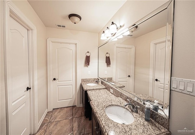 bathroom featuring tile patterned flooring and vanity