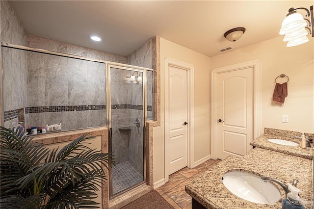 bathroom featuring vanity and a shower with door