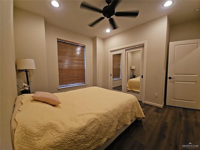 bedroom featuring dark wood-type flooring, ceiling fan, and a closet