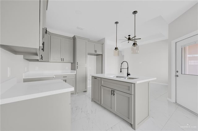 341 Leon Ave, Elsa, TX 78543 - kitchen with gray cabinetry, light marble finish floors, pendant lighting, light countertops, and ceiling fan