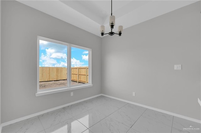 341 Leon Ave, Elsa, TX 78543 - empty room with light marble finish flooring and a chandelier