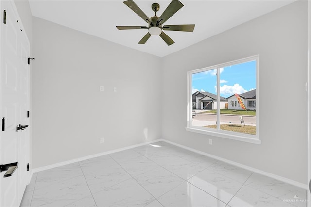 341 Leon Ave, Elsa, TX 78543 - unfurnished room featuring light marble finish flooring and ceiling fan