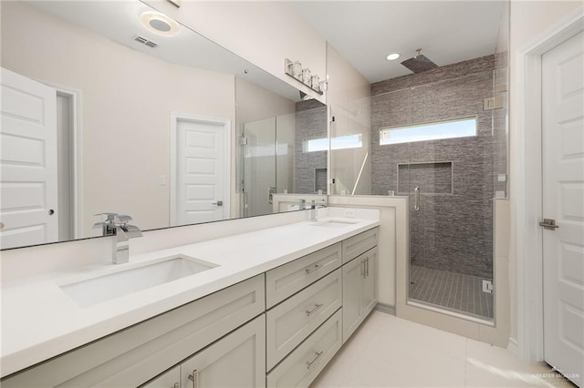 bathroom with vanity, tile patterned flooring, and a shower with door