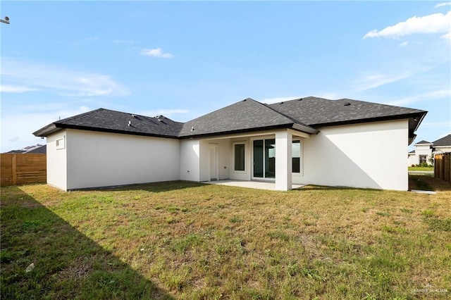 back of house featuring a yard and a patio area