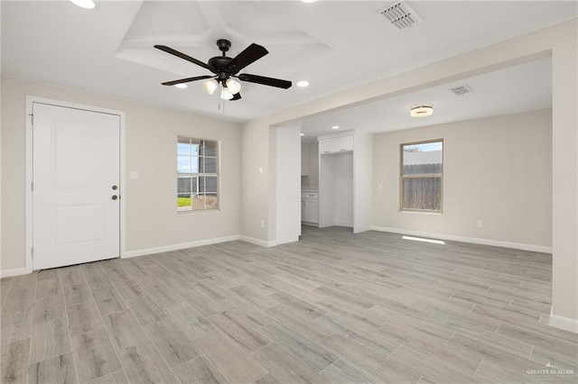 unfurnished living room with visible vents, baseboards, and light wood-style floors