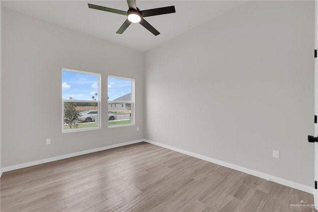 unfurnished room with ceiling fan, light wood finished floors, and baseboards