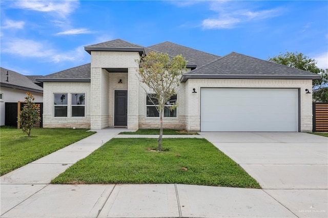 view of front of property with roof with shingles, an attached garage, brick siding, and driveway