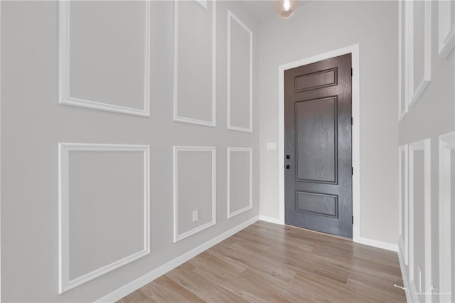 foyer entrance featuring wood finished floors and baseboards