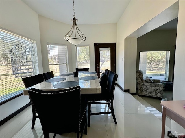 dining space with light tile patterned flooring and baseboards