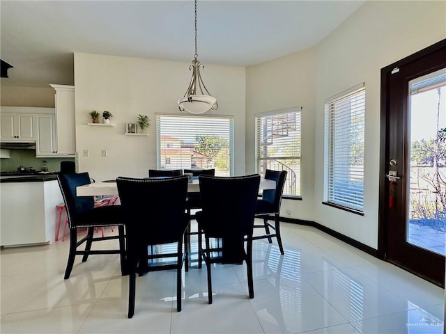 dining area with plenty of natural light, baseboards, and light tile patterned floors