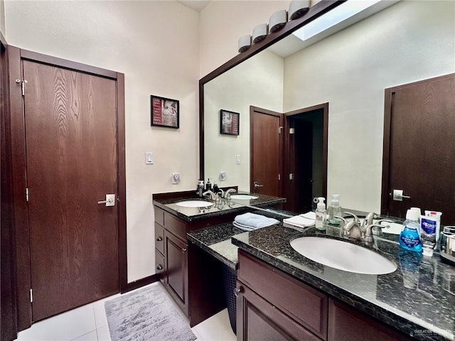 full bathroom featuring baseboards, vanity, and tile patterned floors