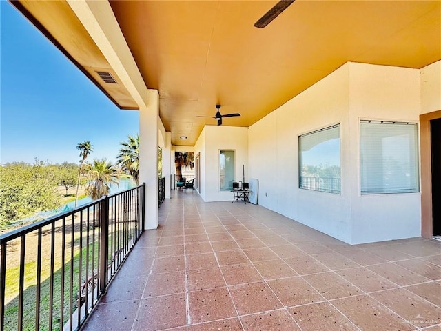 view of patio featuring visible vents, ceiling fan, and a balcony