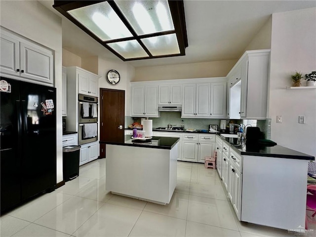 kitchen with a kitchen island, dark countertops, black fridge with ice dispenser, and white cabinetry