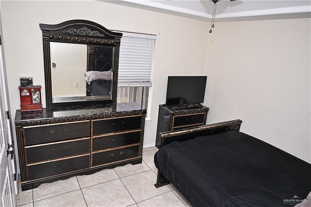 bedroom with ceiling fan and light tile patterned floors