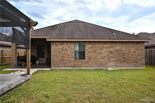 back of house featuring a yard and a deck