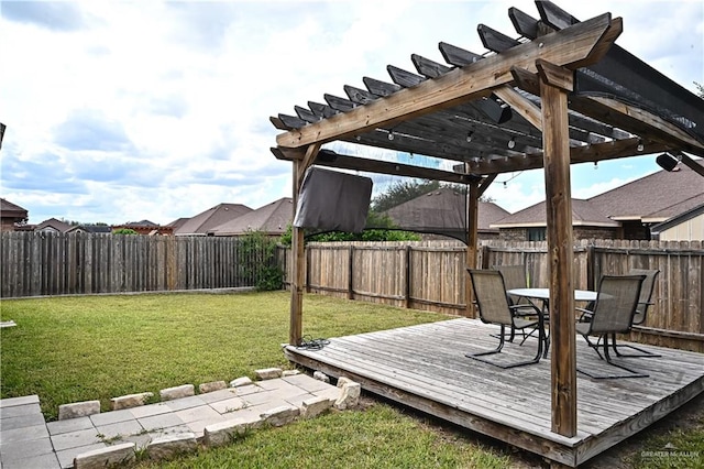 wooden deck featuring a lawn and a pergola