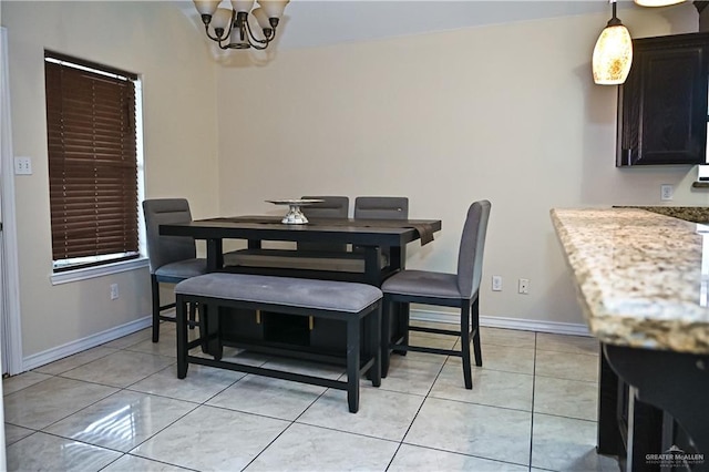 tiled dining space featuring a notable chandelier