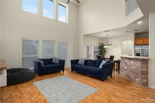 living room featuring a notable chandelier and light hardwood / wood-style floors