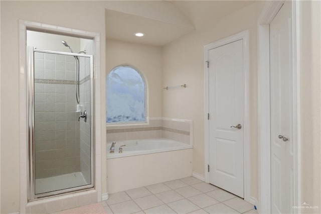 bathroom featuring independent shower and bath and tile patterned flooring