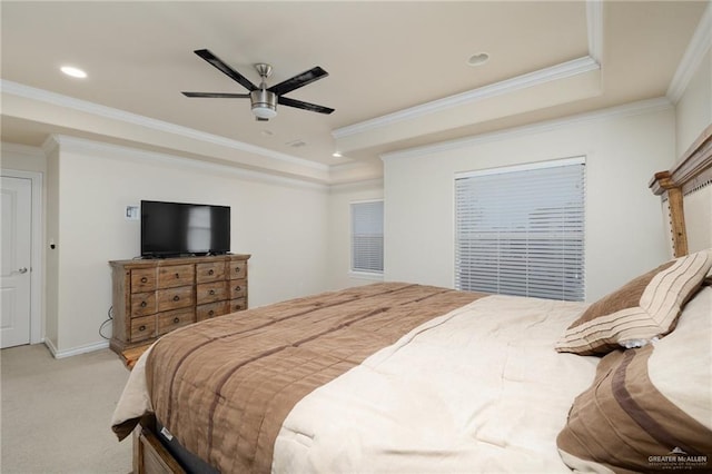 bedroom with light carpet, crown molding, a tray ceiling, and ceiling fan