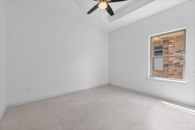1212 Bridle Way, San Benito, TX 78586 - spare room featuring ceiling fan and baseboards