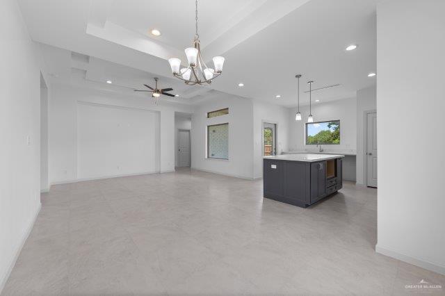 1212 Bridle Way, San Benito, TX 78586 - kitchen with a chandelier, light countertops, recessed lighting, ceiling fan, and decorative light fixtures