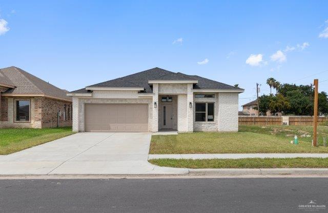 1212 Bridle Way, San Benito, TX 78586 - view of front of home with an attached garage, driveway, and brick siding