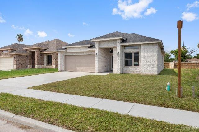 1212 Bridle Way, San Benito, TX 78586 - prairie-style home with a garage, concrete driveway, and brick siding