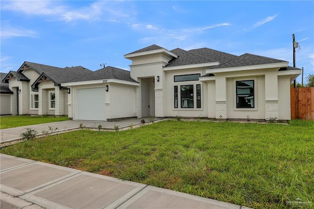 prairie-style home with a garage and a front lawn