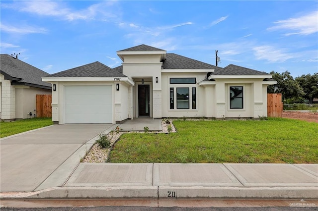 prairie-style home with a front yard and a garage