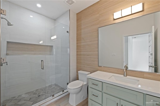 1218 N Lincoln Ave, San Juan, TX 78589 - bathroom with toilet, vanity, a shower stall, tile walls, and recessed lighting