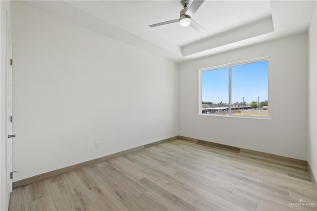 1218 N Lincoln Ave, San Juan, TX 78589 - empty room with a raised ceiling, a ceiling fan, light wood-style floors, and baseboards