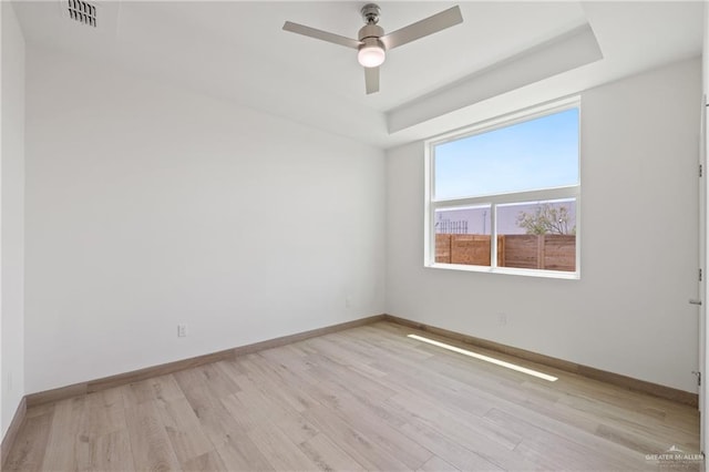 1218 N Lincoln Ave, San Juan, TX 78589 - empty room featuring light wood-style flooring, a ceiling fan, baseboards, and a tray ceiling