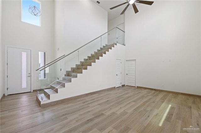 1218 N Lincoln Ave, San Juan, TX 78589 - foyer entrance featuring a towering ceiling, stairs, ceiling fan, wood finished floors, and baseboards