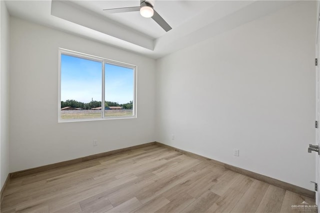 1218 N Lincoln Ave, San Juan, TX 78589 - unfurnished room with a tray ceiling, ceiling fan, light wood-style flooring, and baseboards