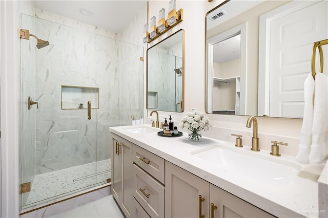 full bathroom featuring double vanity, visible vents, a sink, and a marble finish shower