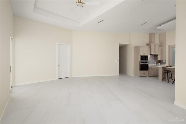 unfurnished living room with baseboards and visible vents