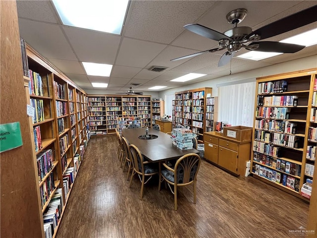 252 Rebecca Dr, Alamo, TX 78516 - office area featuring wall of books, a ceiling fan, wood finished floors, and a paneled ceiling
