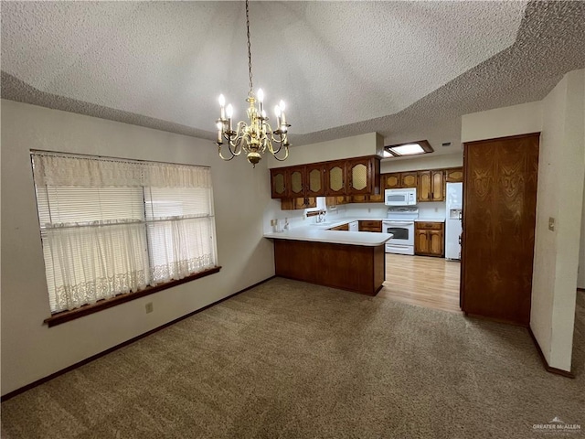 252 Rebecca Dr, Alamo, TX 78516 - kitchen featuring white appliances, a peninsula, light colored carpet, a textured ceiling, and a chandelier