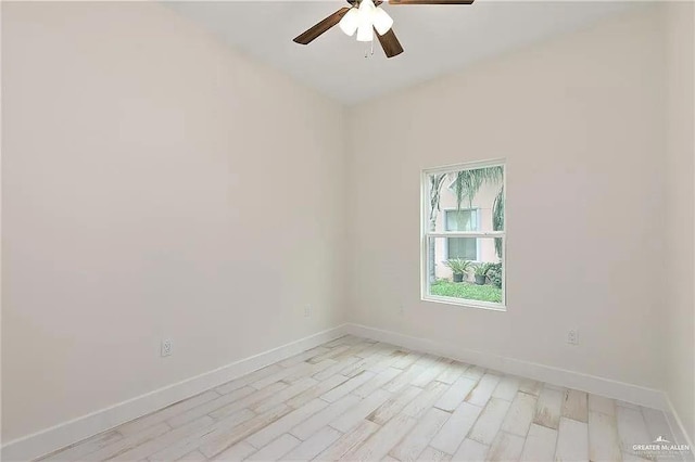 spare room with light wood-type flooring and ceiling fan