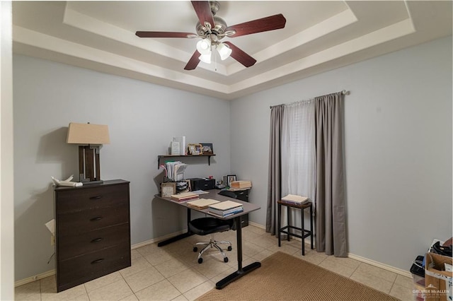 home office with baseboards, a raised ceiling, and light tile patterned flooring