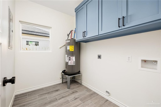 clothes washing area with electric dryer hookup, cabinets, light hardwood / wood-style flooring, washer hookup, and water heater