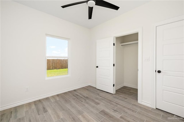 unfurnished bedroom featuring ceiling fan, light wood-type flooring, and a closet