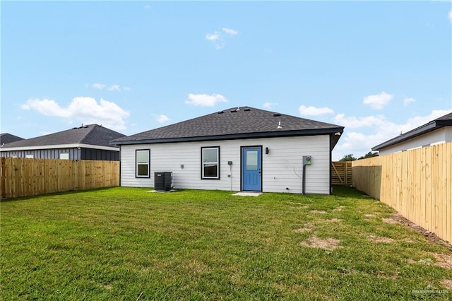 back of property featuring a lawn and cooling unit