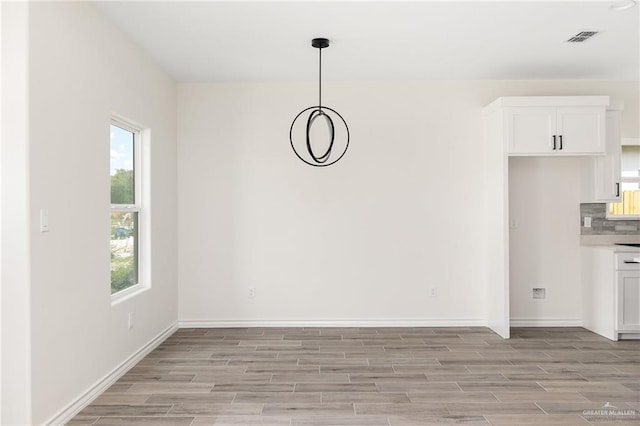 unfurnished dining area with light hardwood / wood-style floors